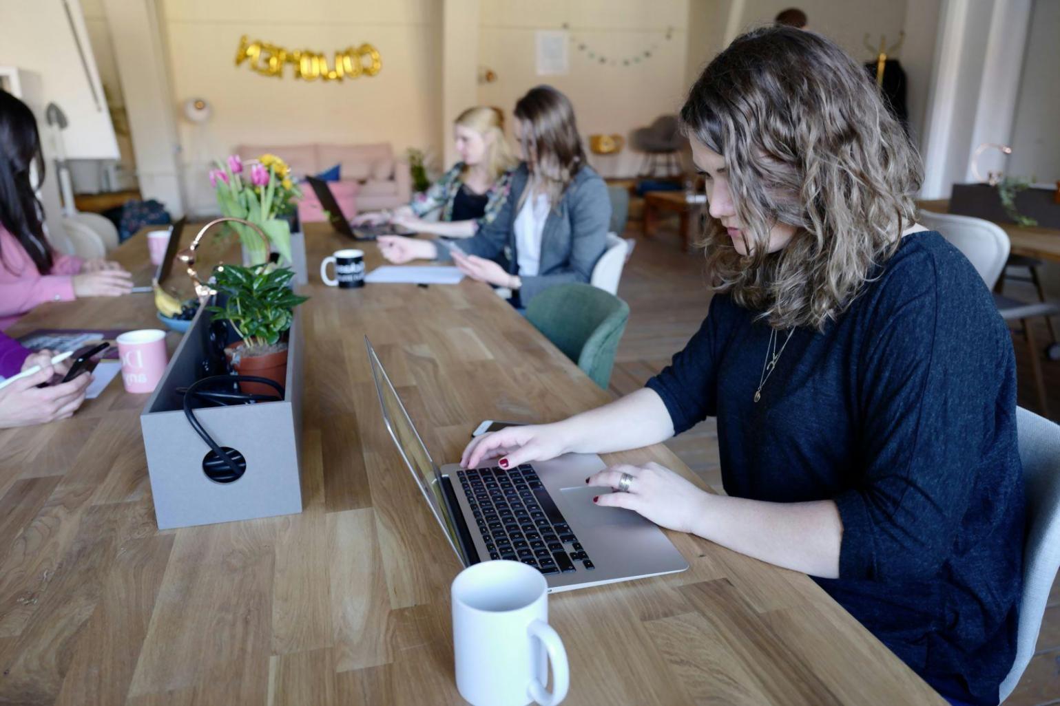 Business professional delivering financial presentation to engaged team